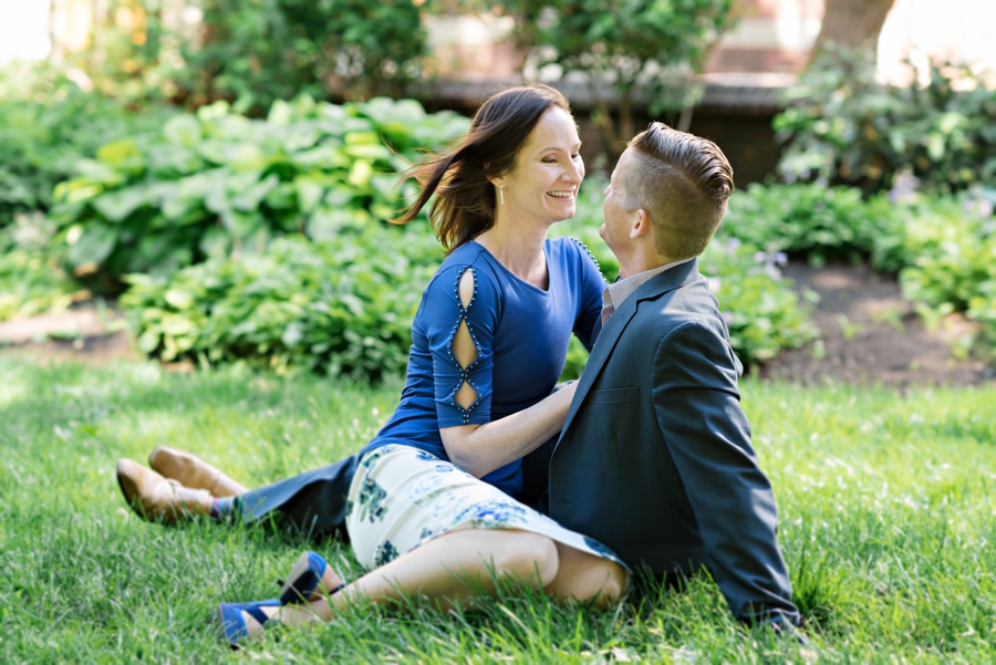 A woman sits in her man's lap in Washington Square Park in Philadelphia for their Engagement Session.